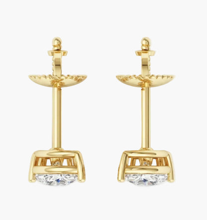 Gold earrings with clear gemstones on a white background