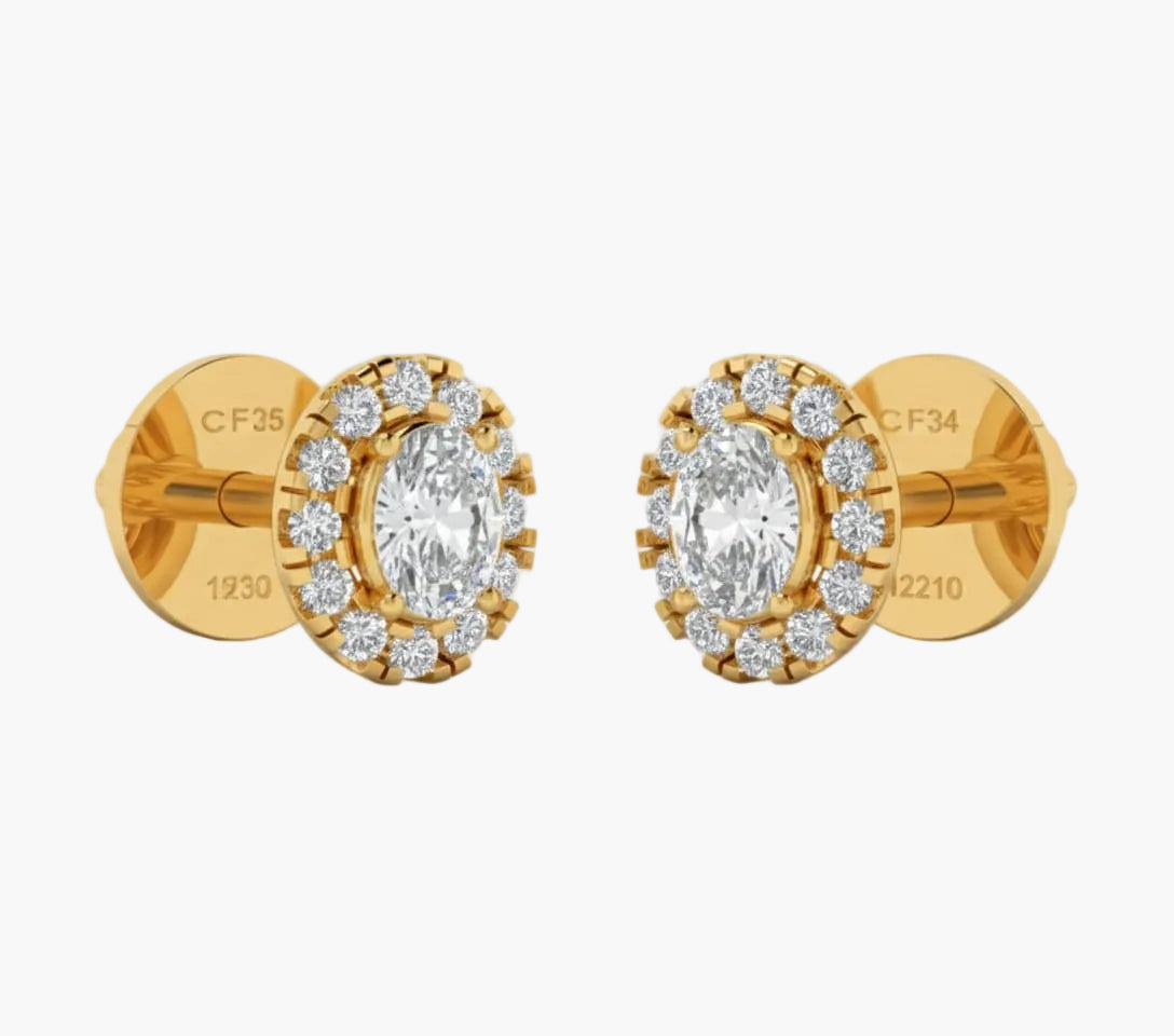 Gold earrings with clear gemstones on a white background