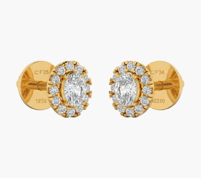 Gold earrings with clear gemstones on a white background