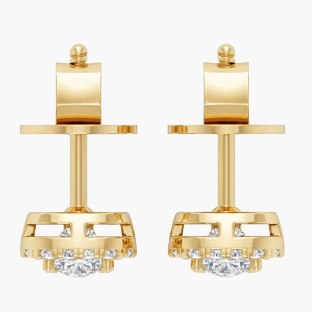 Gold earrings with clear gemstones on a white background