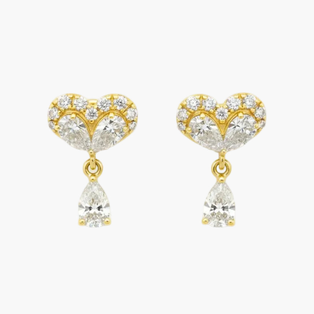 Gold heart-shaped earrings with clear gemstones on a white background