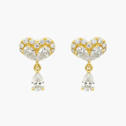 Gold heart-shaped earrings with clear gemstones on a white background