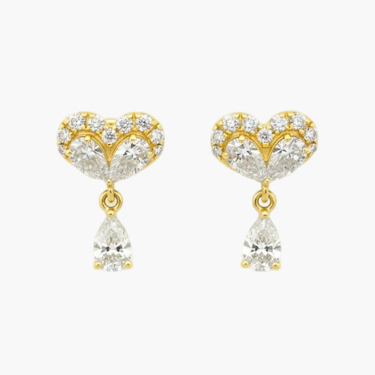 Gold heart-shaped earrings with clear gemstones on a white background
