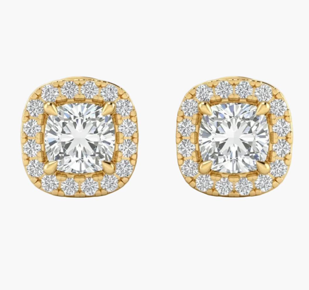 Gold earrings with diamond-like stones on a white background