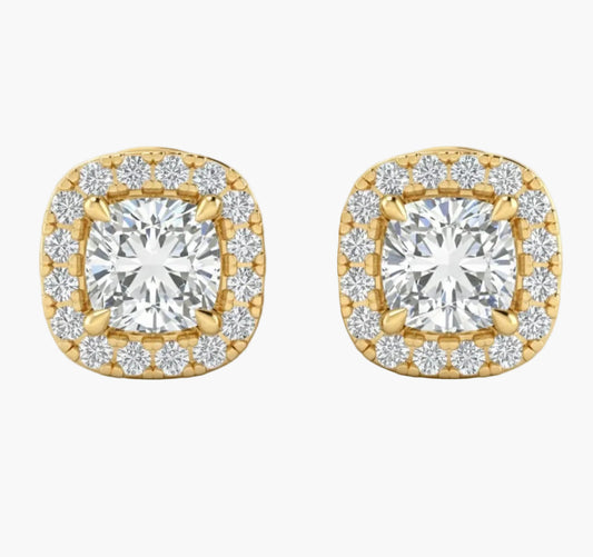 Gold earrings with diamond-like stones on a white background