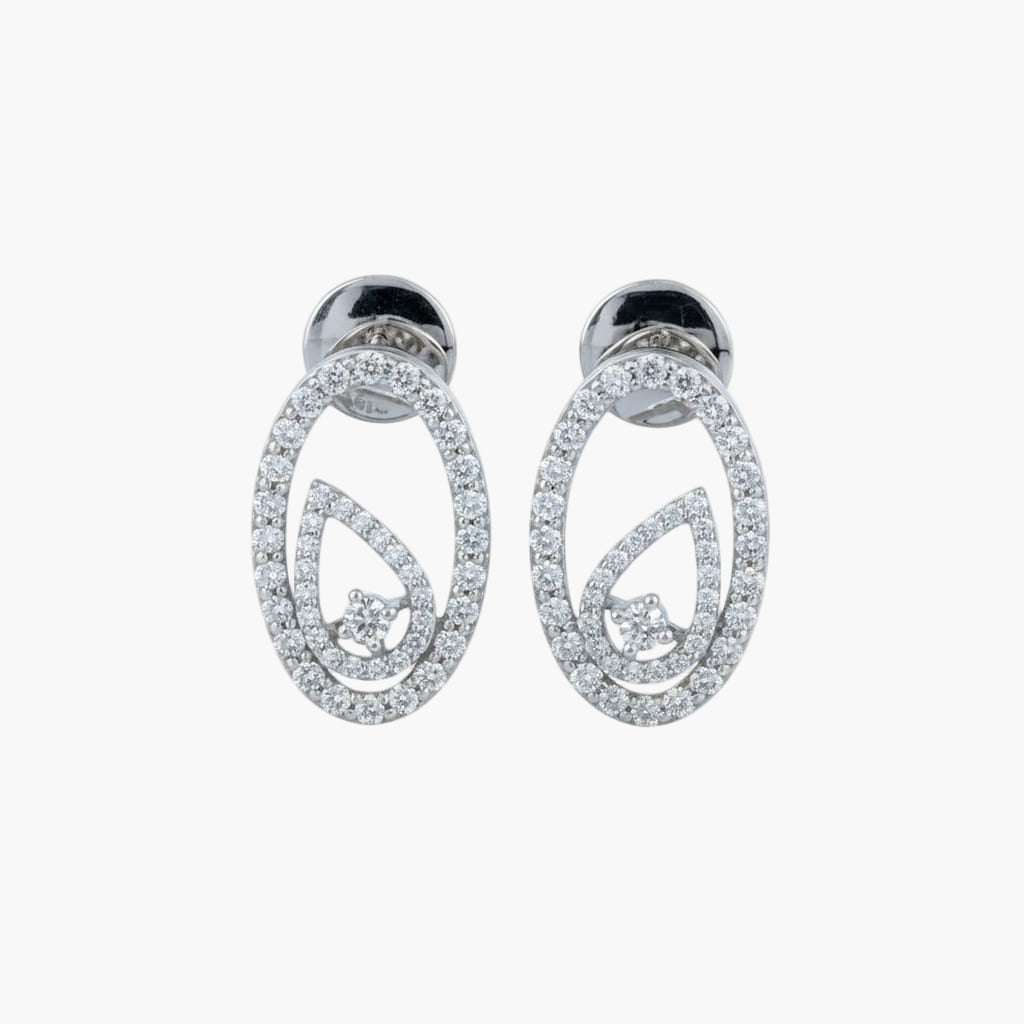 Pair of silver earrings with circular design on a white background
