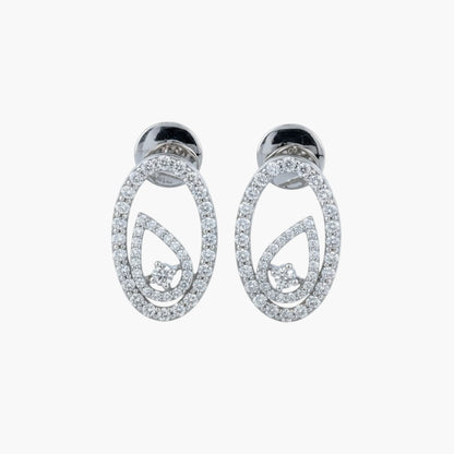 Pair of silver earrings with circular design on a white background