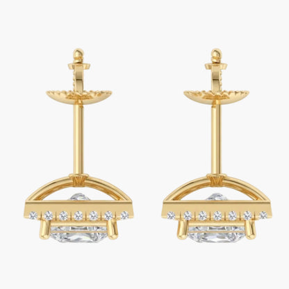 Gold earrings with clear gemstones on a white background