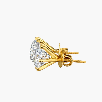 Gold earrings with clear gemstones on a white background