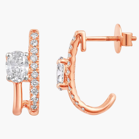 Rose gold hoop earrings with clear gemstones on a white background