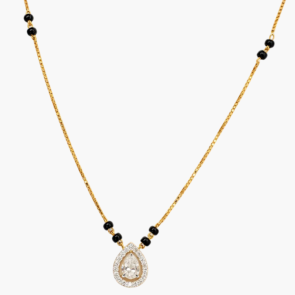 Gold necklace with a teardrop-shaped pendant and black beads on a white background