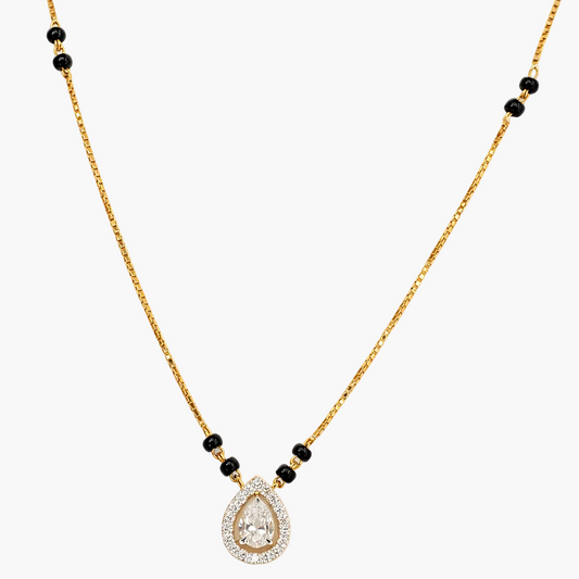 Gold necklace with a teardrop-shaped pendant and black beads on a white background