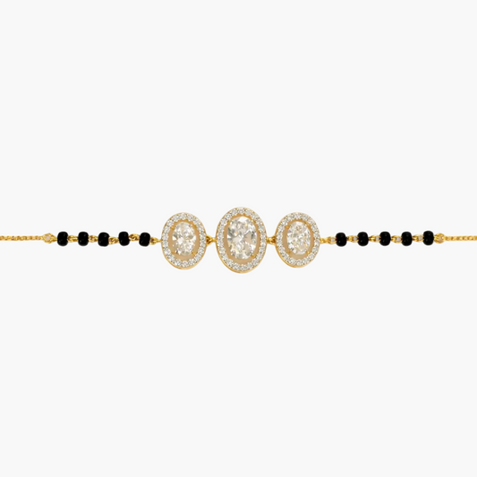 Gold and black beaded necklace on a white background