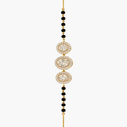 Gold and black beaded necklace on a white background