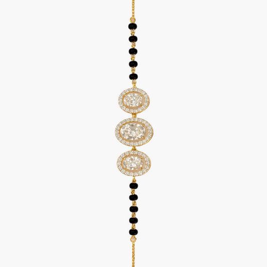 Gold and black beaded necklace on a white background