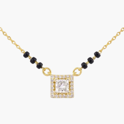 Gold necklace with a square diamond pendant on a white background