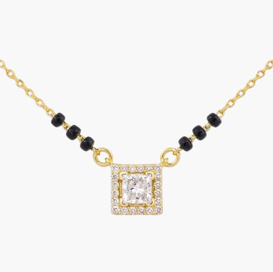 Gold necklace with a square diamond pendant on a white background