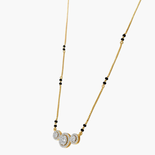 Gold necklace with black beads and a pendant on a white background