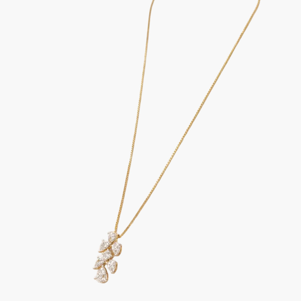 Gold necklace with a delicate pendant on a white background
