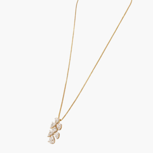 Gold necklace with a delicate pendant on a white background