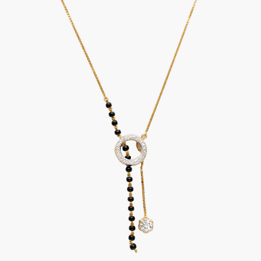 Necklace with black beads and gold chain on a white background