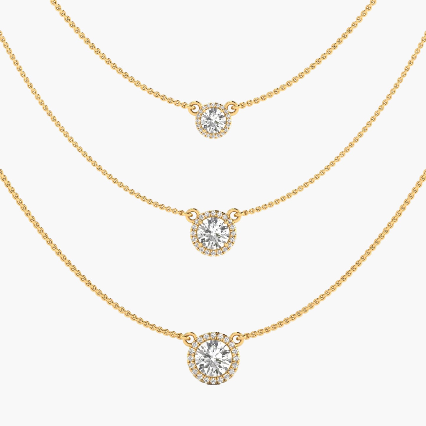 Three gold necklaces with round diamond pendants on a white background
