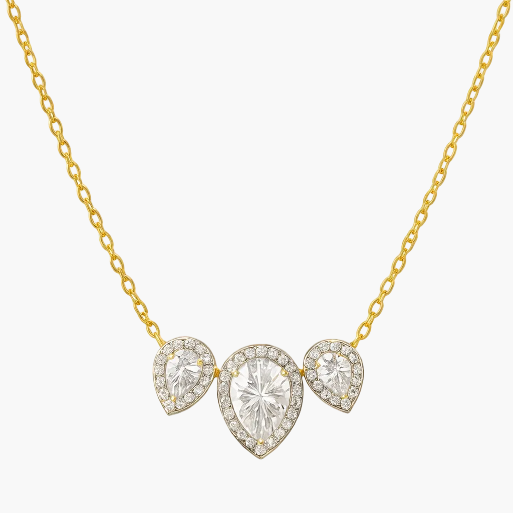 Gold necklace with three heart-shaped diamond pendants on a white background
