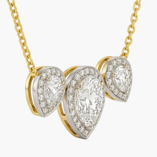 Gold and silver necklace with teardrop-shaped diamond pendants on a white background