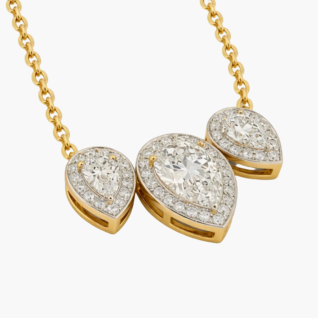Gold necklace with teardrop-shaped diamond pendants on a white background