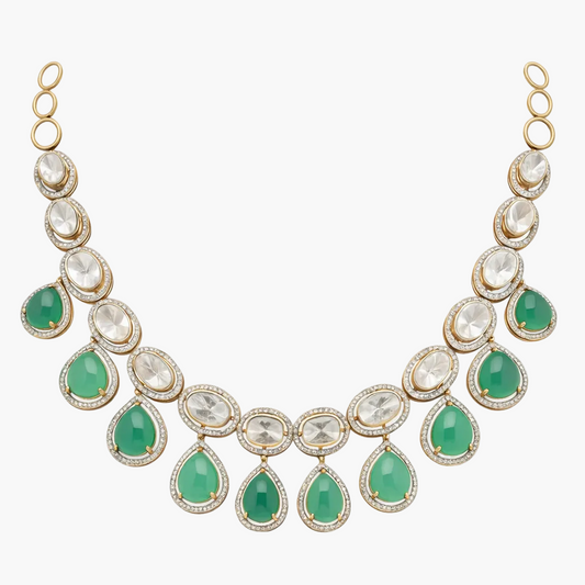 Necklace with green teardrop and clear gemstones on a white background