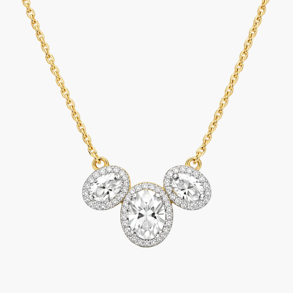 Gold necklace with three circular diamond pendants on a white background