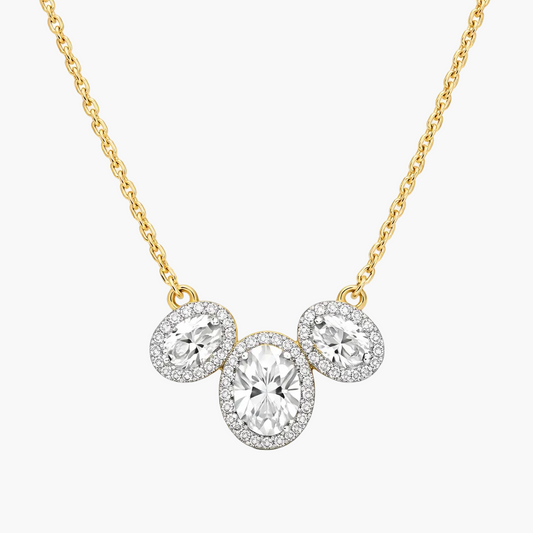 Gold necklace with three circular diamond pendants on a white background