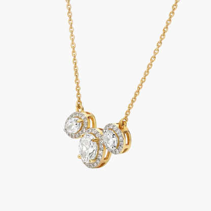 Gold necklace with three circular diamond pendants on a white background