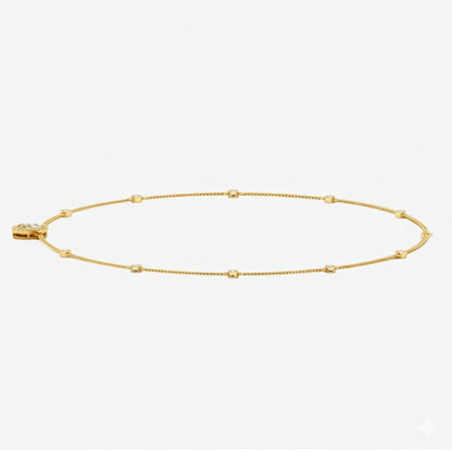 Gold necklace with a pear-shaped diamond pendant on a white background