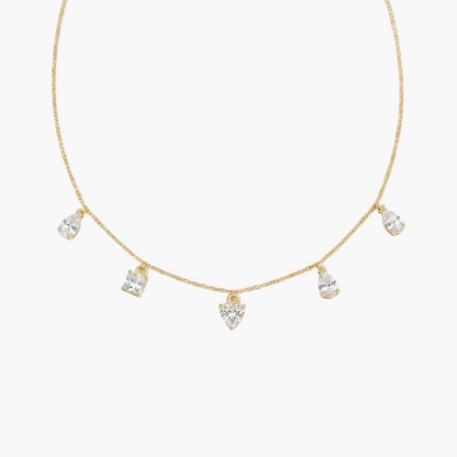 Gold necklace with teardrop-shaped diamonds on a white background