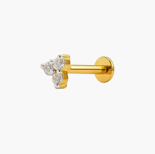 Gold earring with clear gemstones on a white background