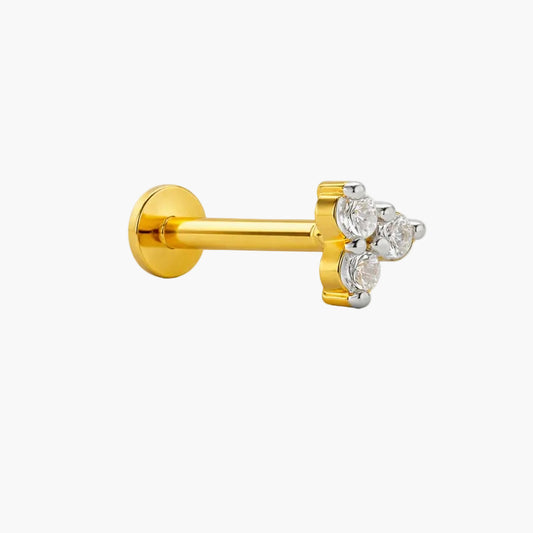 Gold labret with three clear gemstones on a white background