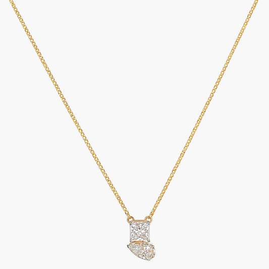 Gold necklace with a diamond pendant on a white background