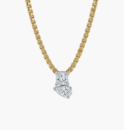 Gold necklace with a diamond pendant on a white background