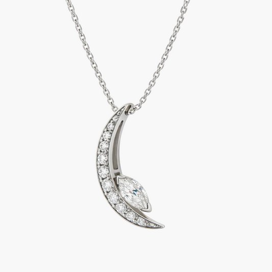 Silver crescent moon necklace with diamonds on a white background