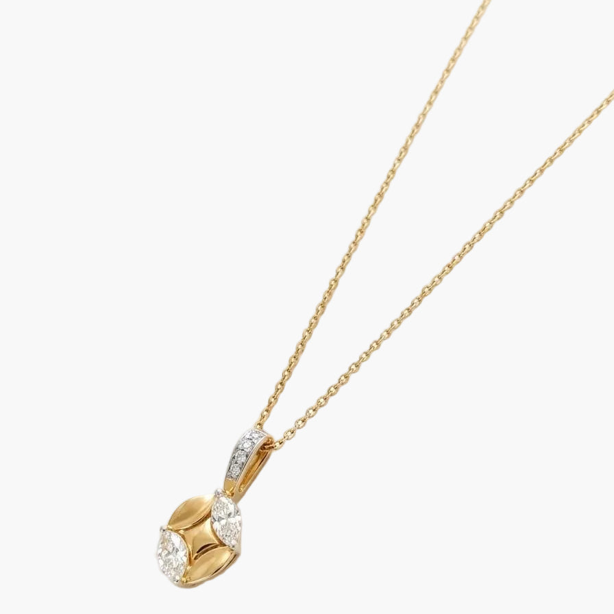 Gold necklace with a heart-shaped pendant on a white background