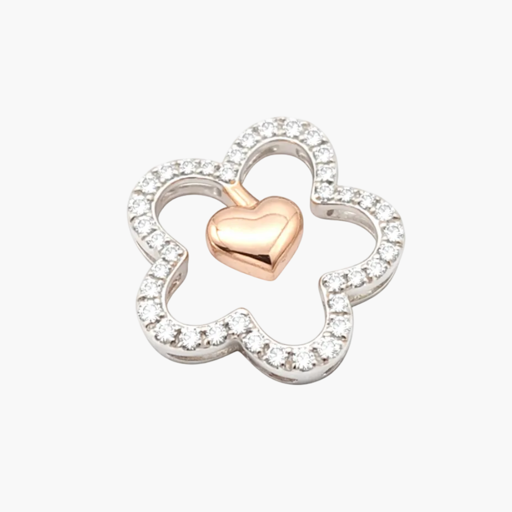 Jewelry charm with heart and clover design on a white background