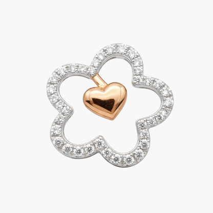 Jewelry pendant with rose gold heart and silver clover design on a white background