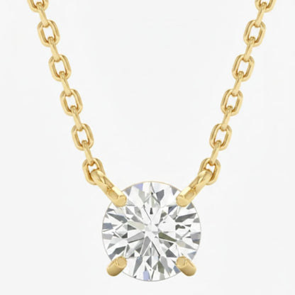 Gold necklace with a round diamond pendant on a white background