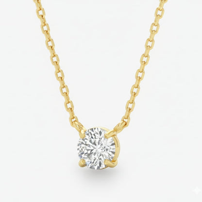 Gold necklace with a diamond pendant on a light gray background