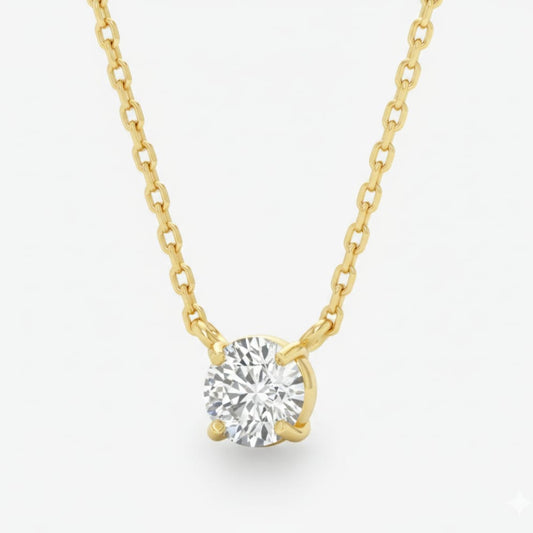 Gold necklace with a diamond pendant on a light gray background