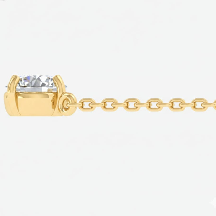 Gold chain necklace with a clear gemstone on a white background