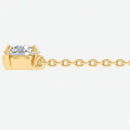Gold chain necklace with a clear gemstone on a white background