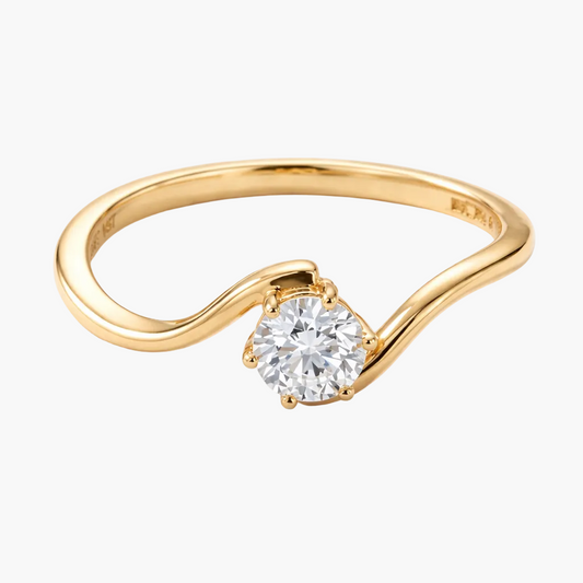 Gold ring with a diamond on a white background