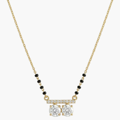 Gold necklace with diamond pendant on a white background